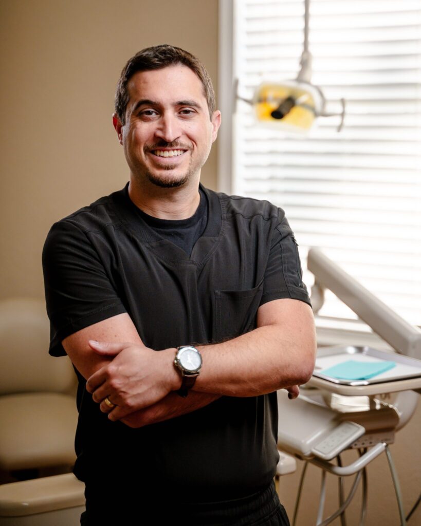 Smiling Dentist in black uniform