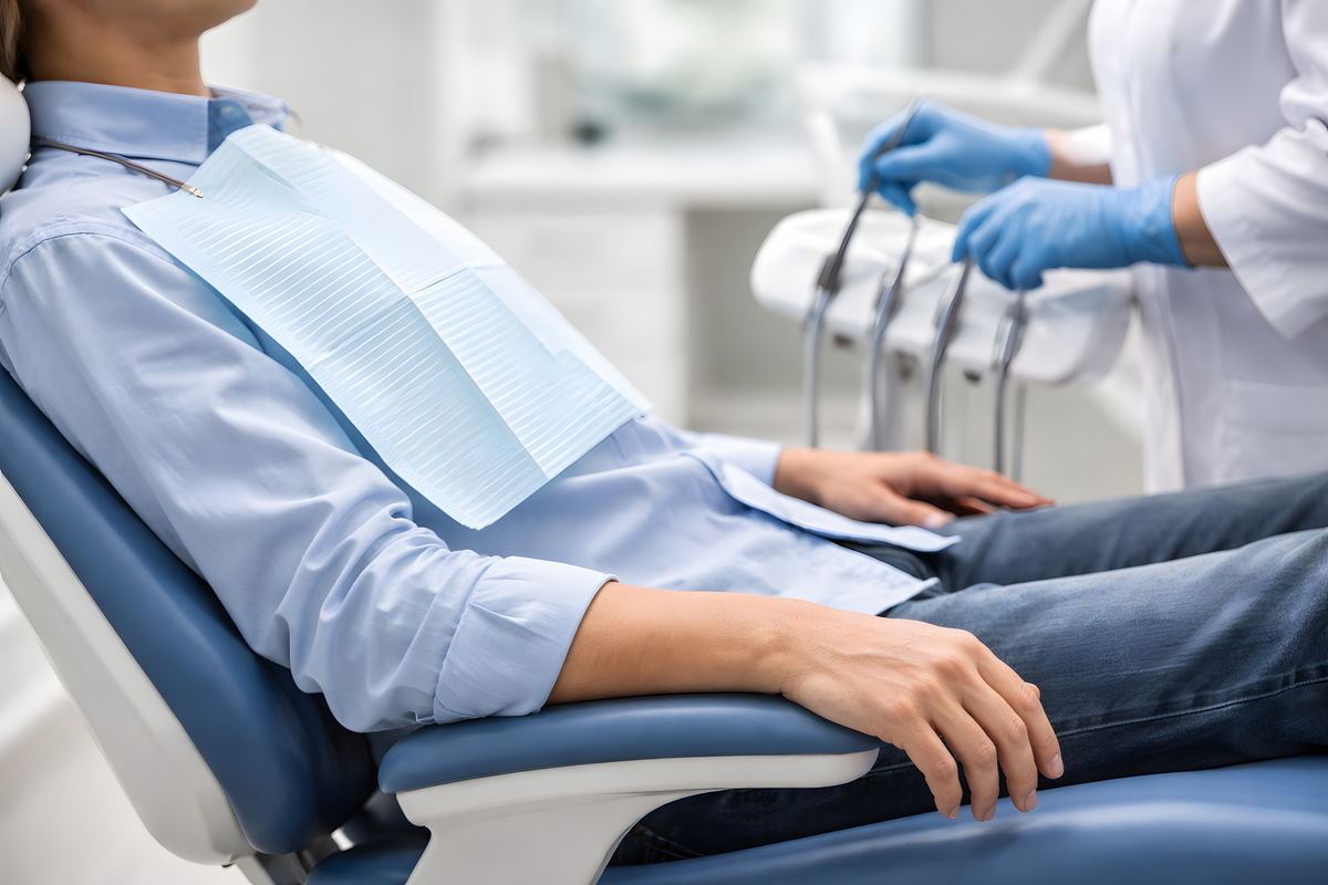 AdobeStock 1874703378 - Viera Dental Arts | Dentist in Melbourne FL Patient in Dental Chair During Dental Visit, Face Not Visible