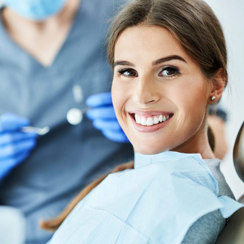 Male dentist and woman in dental clinic