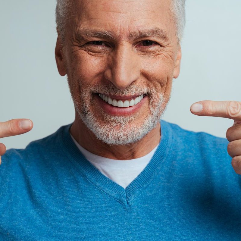 Handsome senior isolated on grey background. Concept about the third age and seniority