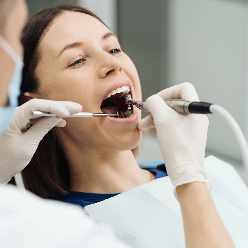 Overview of dental caries prevention. Girl at the dentist chair during a dental scaling procedure. Healthy Smile.